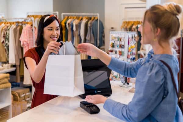 A cashier interacting with a customer