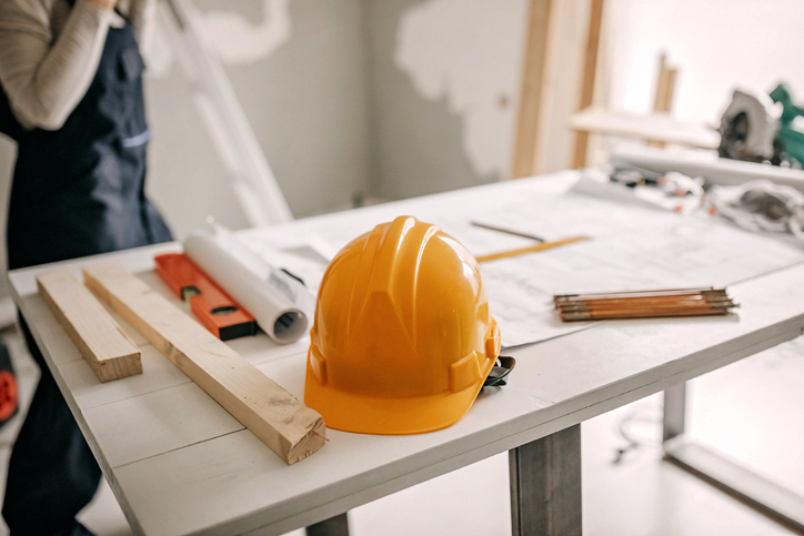 A hardhat sitting on a workbench.