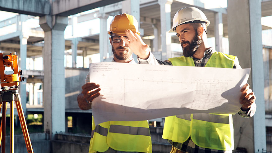 Two engineers working on a commercial building construction site.