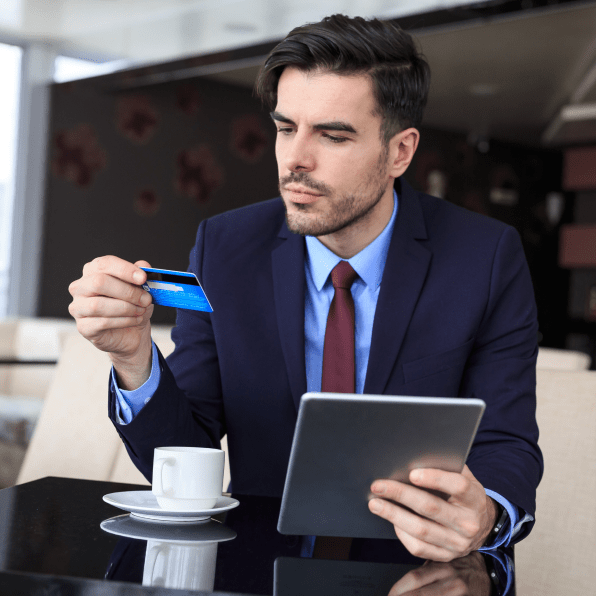 Man reviewing credit card on his tablet